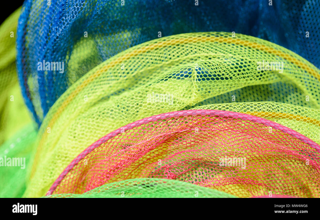 Colourful children's fishing nets for sale outside a shop at the seaside Stock Photo