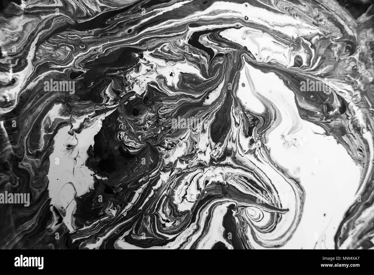 marble texture formed by mixing the black and white acrylic paint, abstract  background Stock Photo
