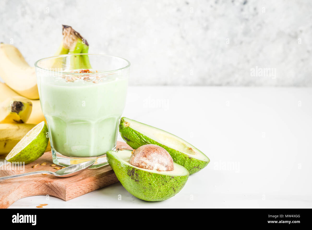Healthy summer drink, avocado and banana smoothie with lime, granola and coconut  milk, dark rusty background copy space Stock Photo - Alamy