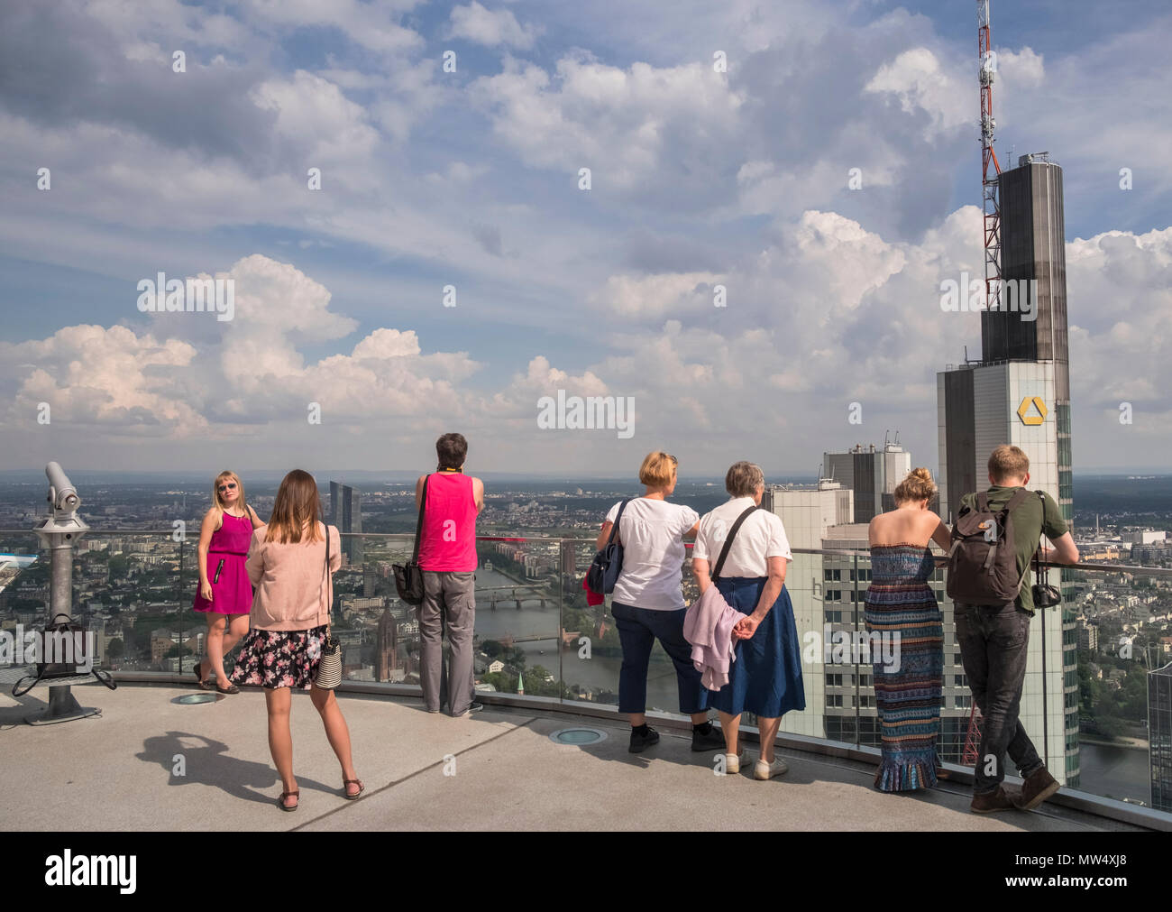 Visitors enjoying westerly views from the observation deck of the 56 storey Main Tower, Neue Mainzer Str, City of Frankfurt am Main, Hesse, Germany. Stock Photo