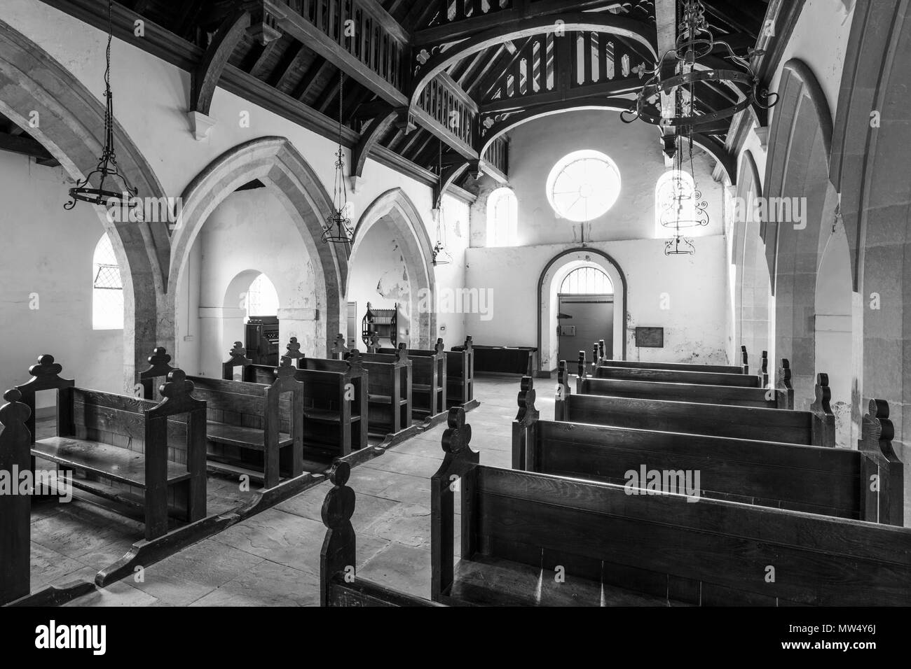 Interior b & w of historic St Martin's Church with wooden pews, aisle & hammerbeam roof in nave -  Allerton Mauleverer, North Yorkshire, England, UK. Stock Photo