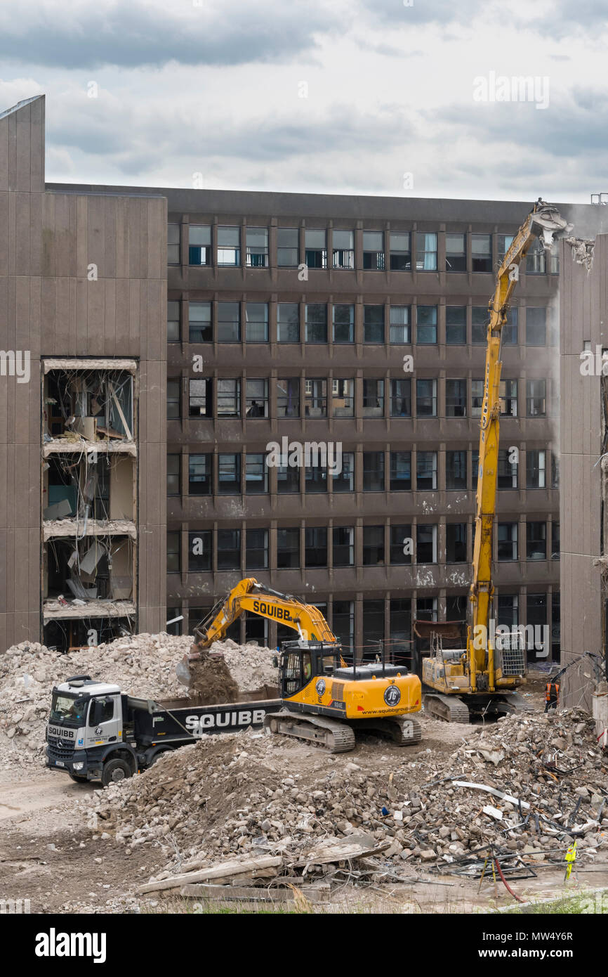 High view of demolition site with heavy machinery (excavators & dumper truck) working & demolishing office building - Hudson House  York, England, UK. Stock Photo