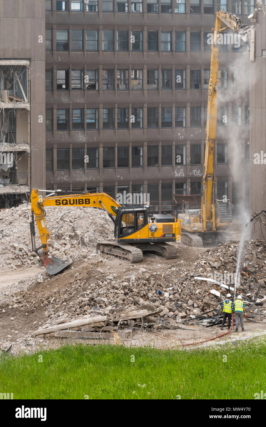 High view of demolition site with rubble, heavy machinery (excavators) working & demolishing empty office building - Hudson House  York, England, UK. Stock Photo