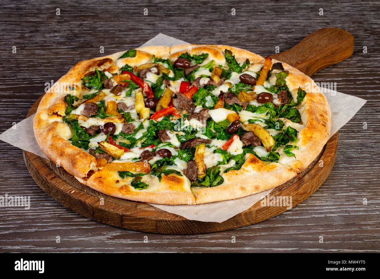 Delicious vegetarien 'Spinach' pizza with olives Stock Photo