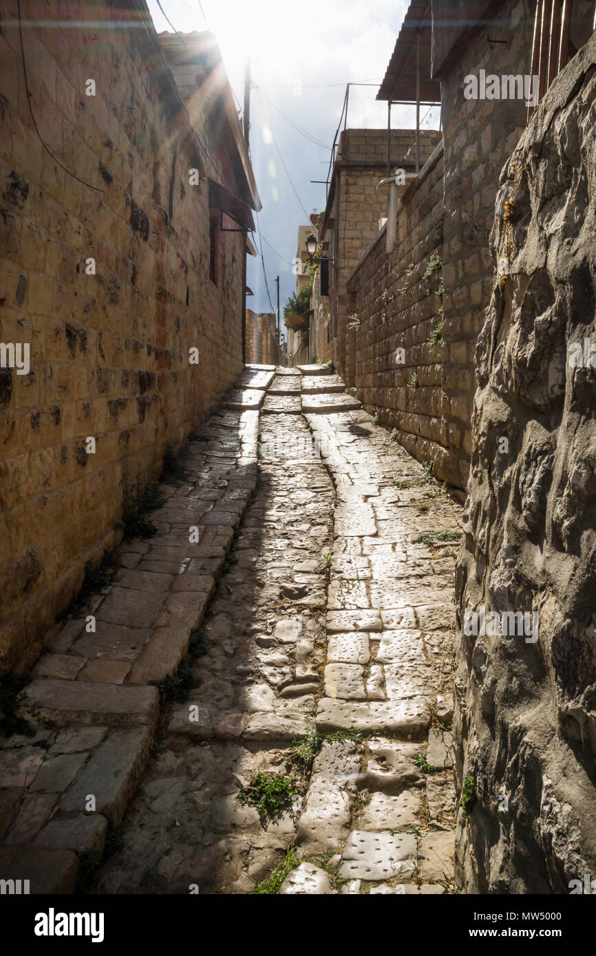 Ancient streets with sunbeam in traditional town Deir el Qamar, Lebanon Stock Photo