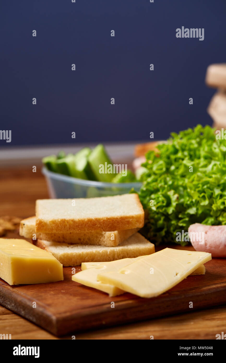 Back to School concept, school supplies, assortment of biscuits and transparent lunchbox full of sandwich, fruits and vegetables togather with assortm Stock Photo