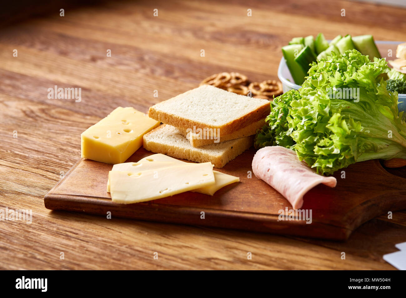 Back to School concept, school supplies, assortment of biscuits and transparent lunchbox full of sandwich, fruits and vegetables togather with assortm Stock Photo