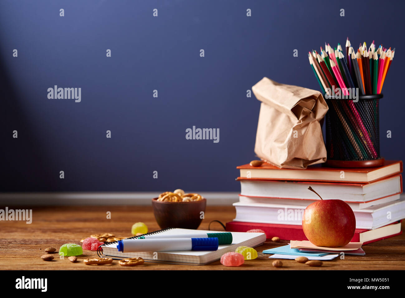 Back to School concept, school supplies, assortment of biscuits and transparent lunchbox full of sandwich, fruits and vegetables togather with assortm Stock Photo