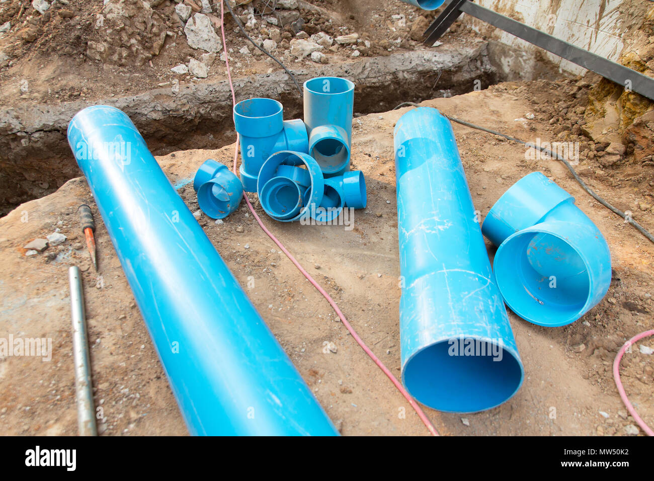 Repair the broken pipe in underground Stock Photo - Alamy