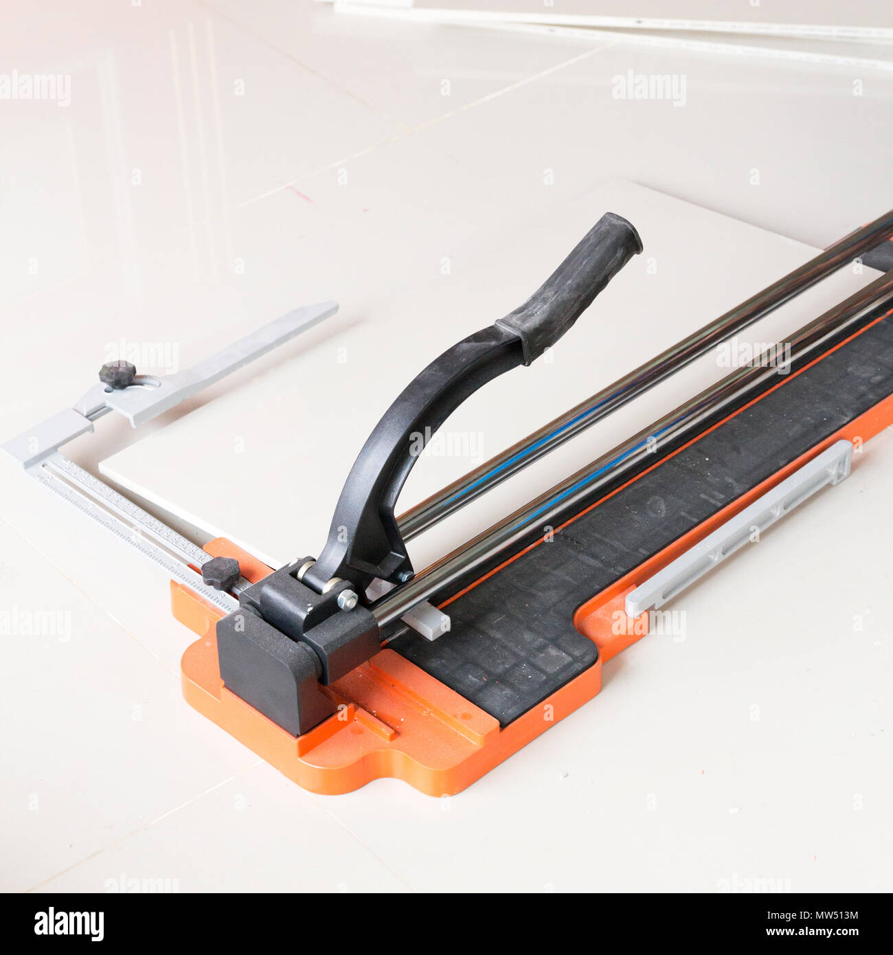 Ceramic tile cutting process using a manual cutter Stock Photo Alamy