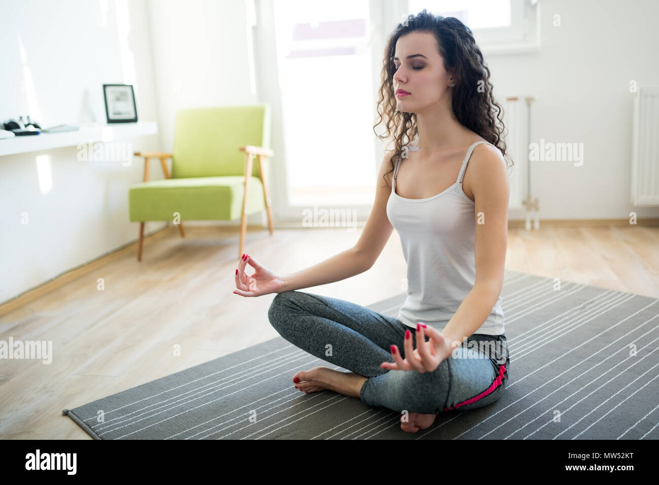 Young attractive woman relaxing and practicing yoga Stock Photo