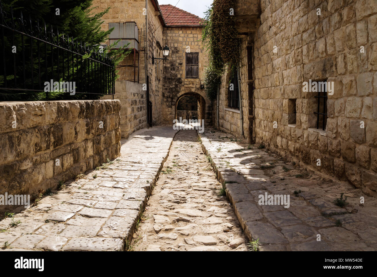 Ancient streets with arch through house in traditional town Deir el Qamar, Lebanon Stock Photo