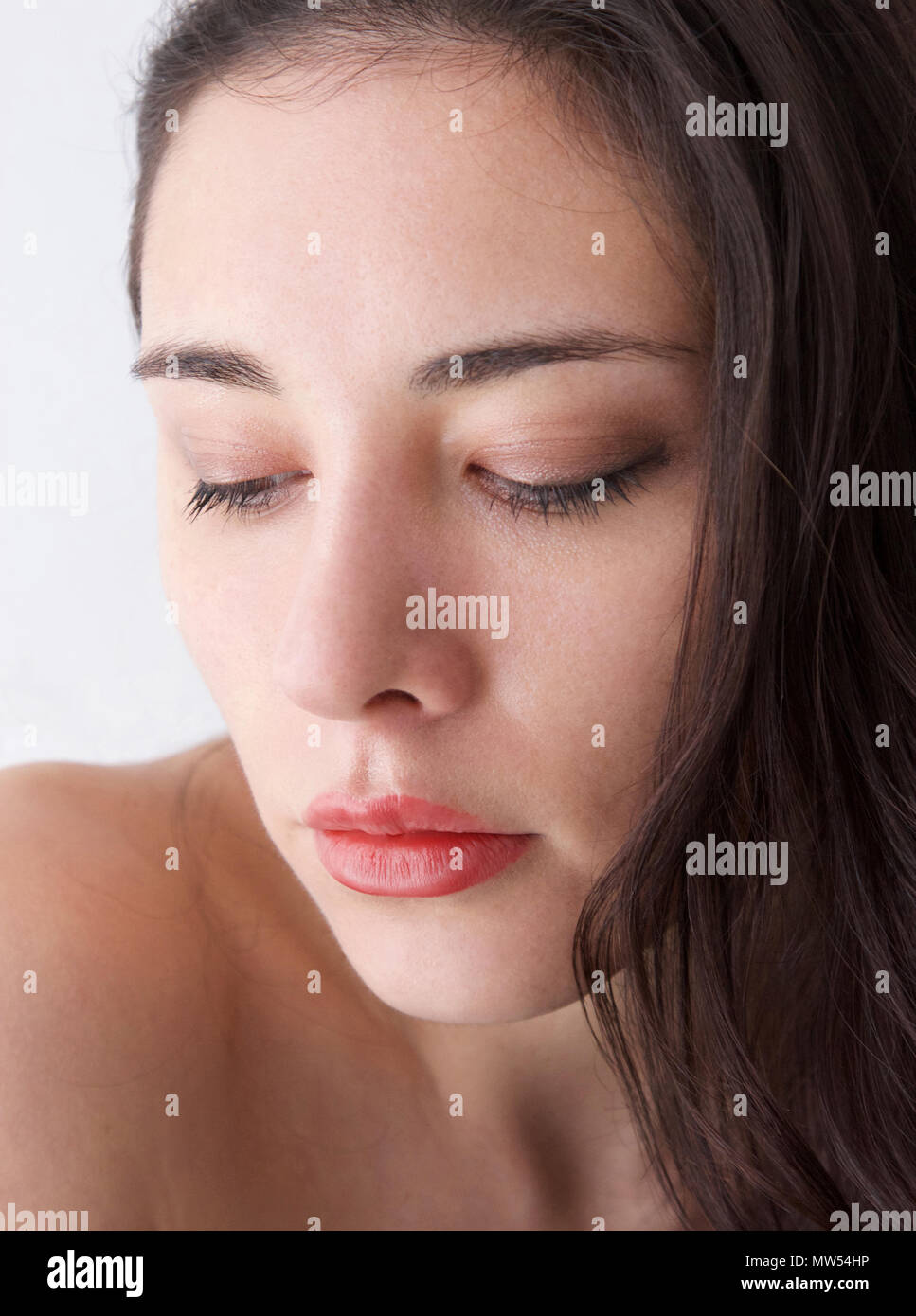 Young italian woman with brown hair and full red lips and downcast eyes Stock Photo Alamy