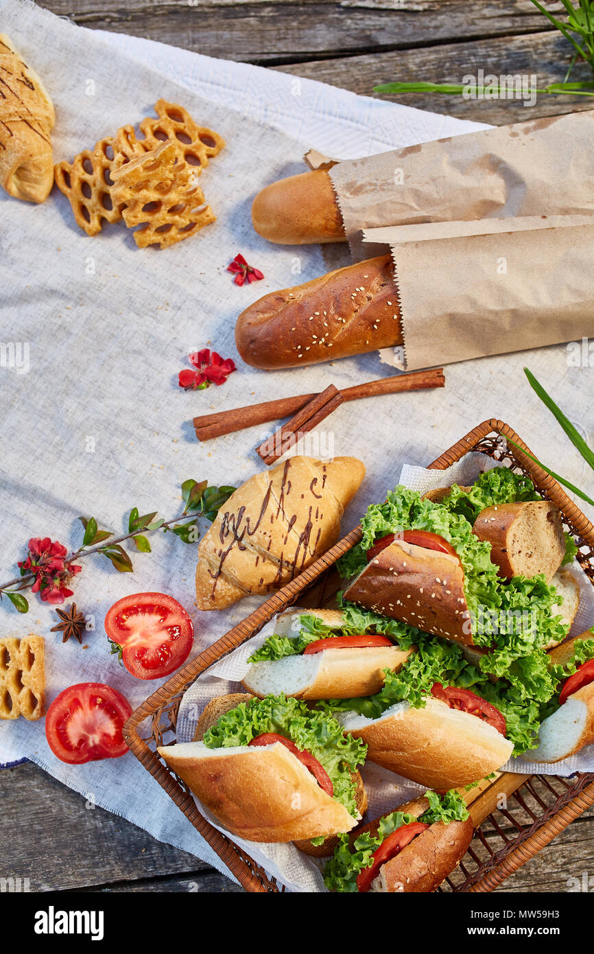 Picnic basket full with sandwiches, baguette and croissant on a homespun  tablecloth, summer season, flat lay, selective focus. Fresh croissants,  bague Stock Photo - Alamy