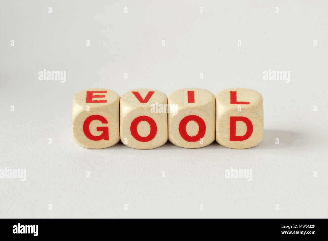 Good and Evil written with wooden cubes Stock Photo