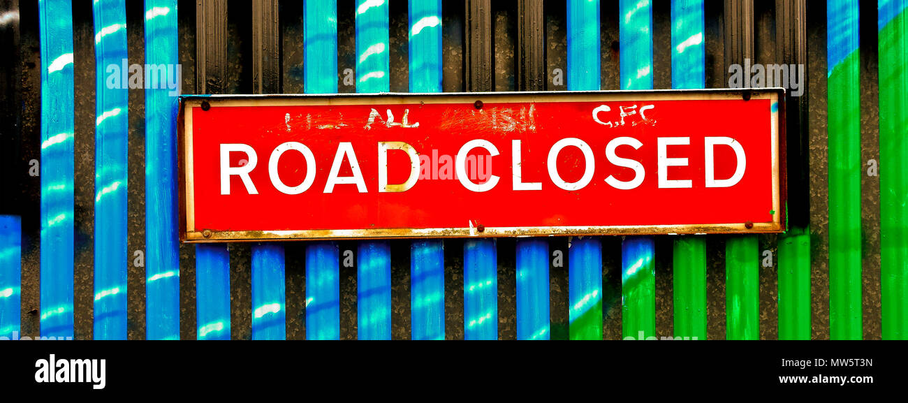 Road closed sign. Security iron gate separating Catholic and Protestant communities, at Belfast peace wall. Northern Ireland, United Kingdom, UK Stock Photo