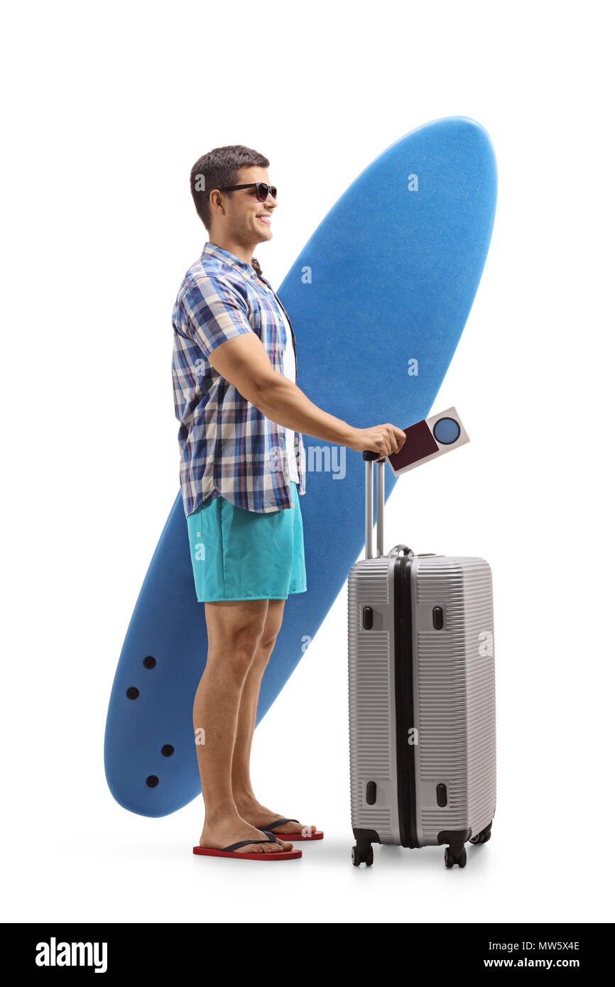 Full length profile shot of a tourist with a surfboard and a suitcase waiting in line isolated on white background Stock Photo