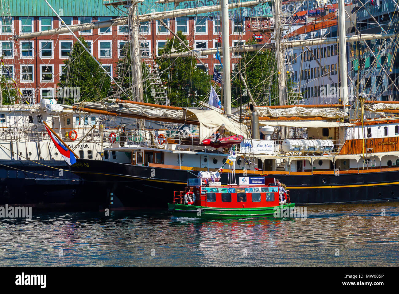 Tall Ships Race Bergen, Norway 2014. Dutch schooner  Gulden Leeuw and UK barque Tenacious with the local harbor ferry Beffen. Stock Photo