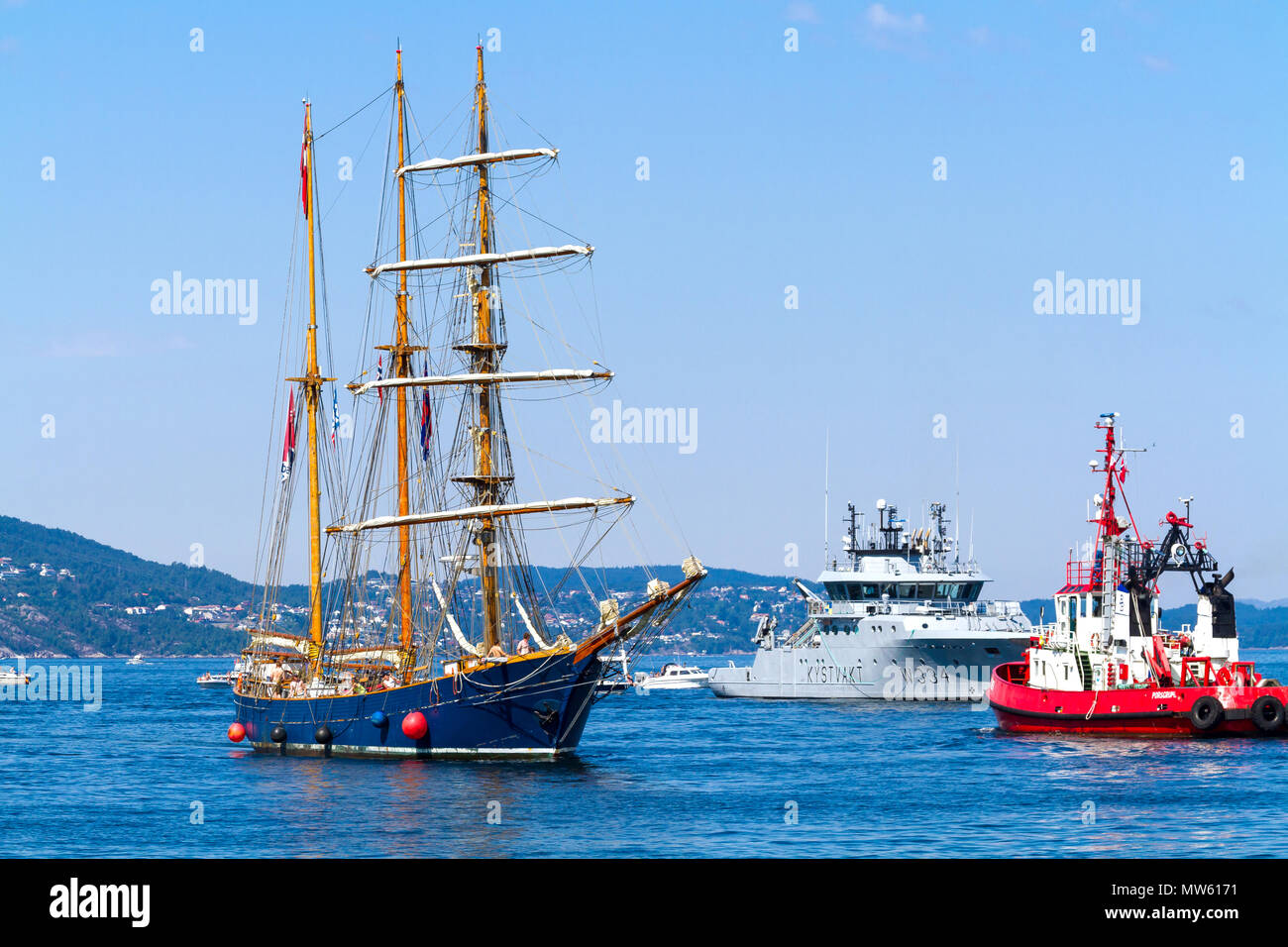 Tall Ships Race Bergen, Norway 2014. Danish barquentine "Loa" entering the  harbor of Bergen. Met by the tugboat Porsgrunn and coastguard vessel Tor  Stock Photo - Alamy