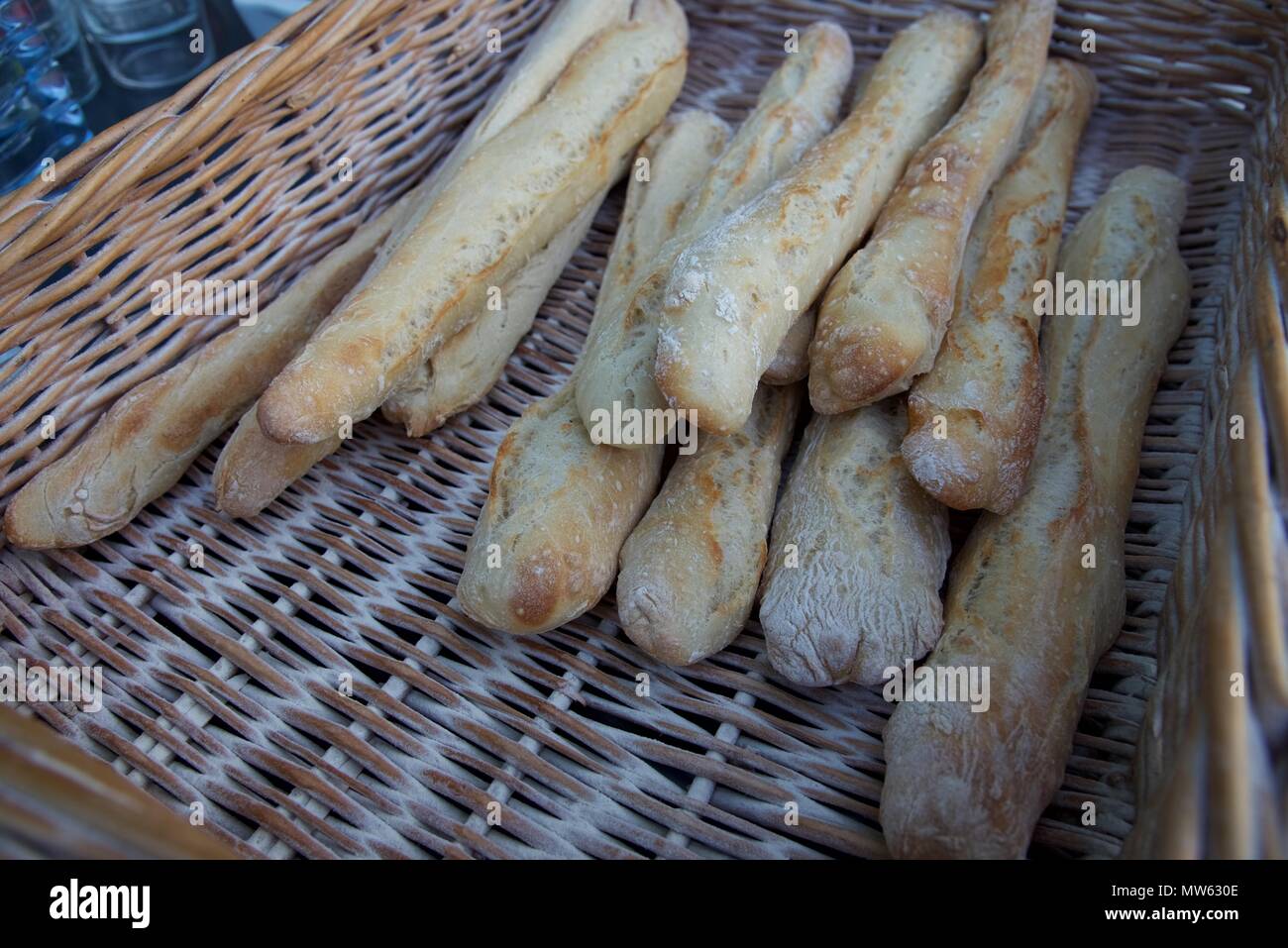 Fresh baked bread a French bread called Ficelle in a wicker basket