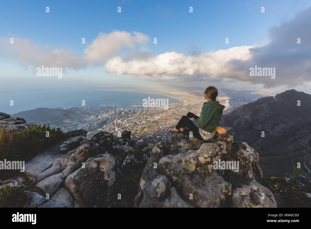 Pretty woman looking over the harbour from Table Mountain in Cape Town Stock Photo