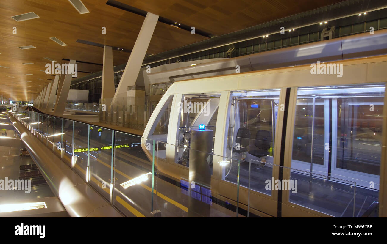 Monorail with train at Doha International Airport, Qatar. Train on the ...