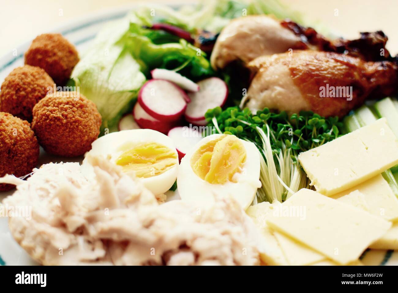Mixed variety salad with chicken, cheddar cheese, scotch and boiled eggs - filter applied Stock Photo