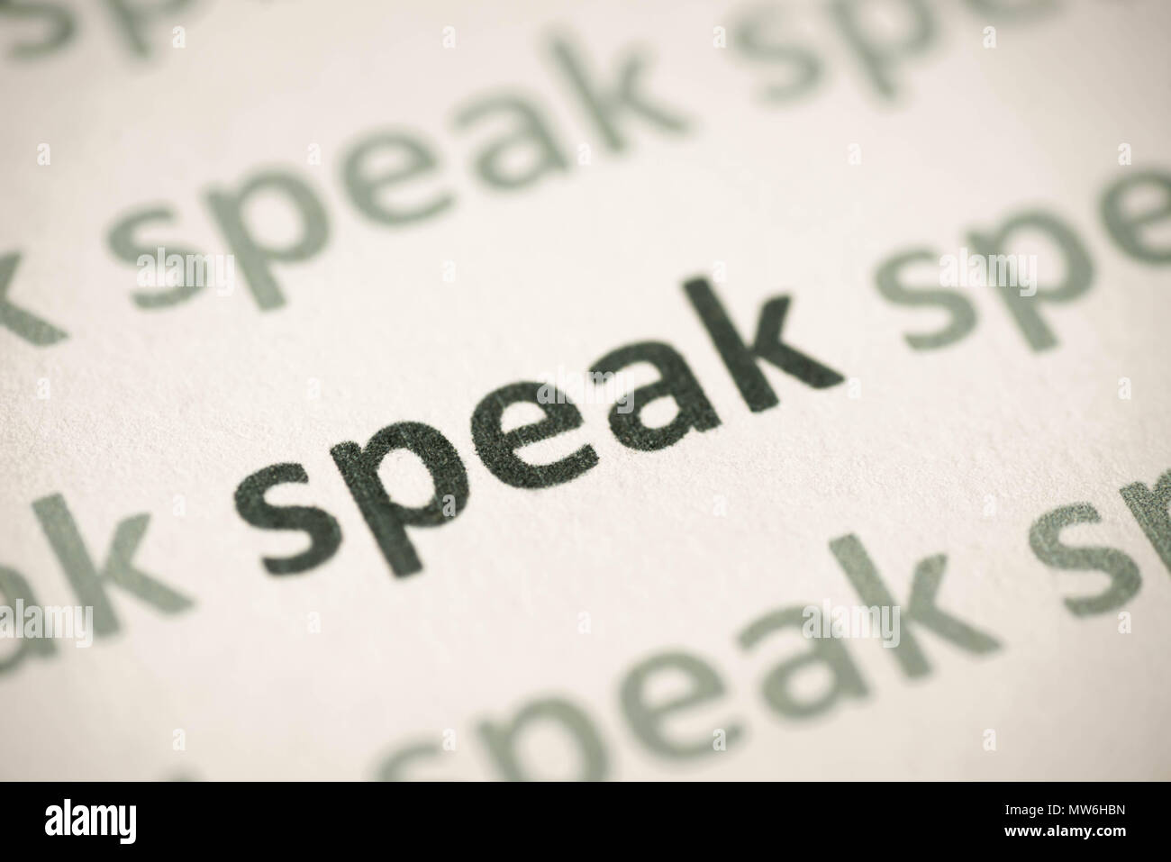 word speak printed on white paper macro Stock Photo