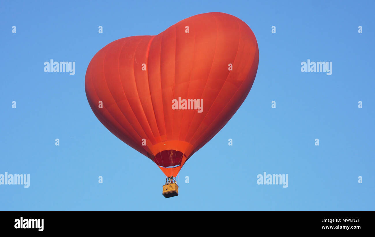 Hot air balloon shape of a heart in the blue sky. Aerostat, Airship ...