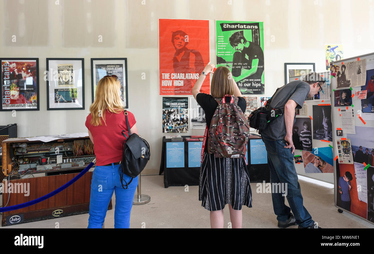 May 19, 2018 - Visitors viewing and photographing posters and other memorabilia at the Charlatans exhibition at the North By Northwich festival, Barons Stock Photo