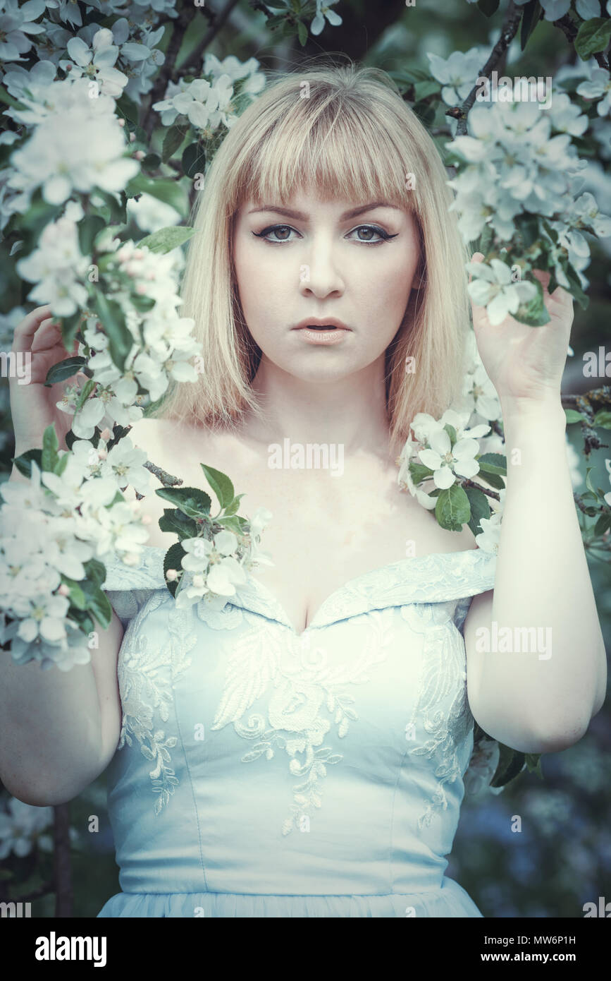 Woman looking at camera in Spring blossom Stock Photo - Alamy