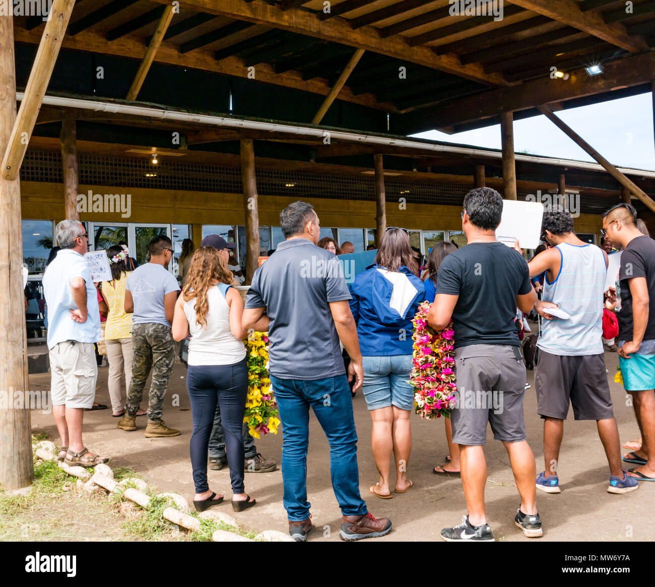 Arrivals at Mataveri International airport, Easter Island, Chile, with tourists being greeted by tour operators welcoming them with lei garlands Stock Photo
