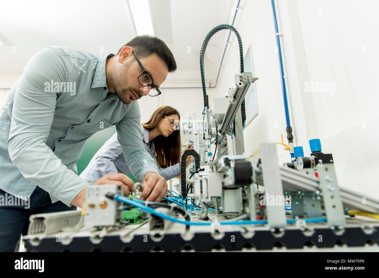 Portrait of young couple of students working at robotics lab Stock Photo