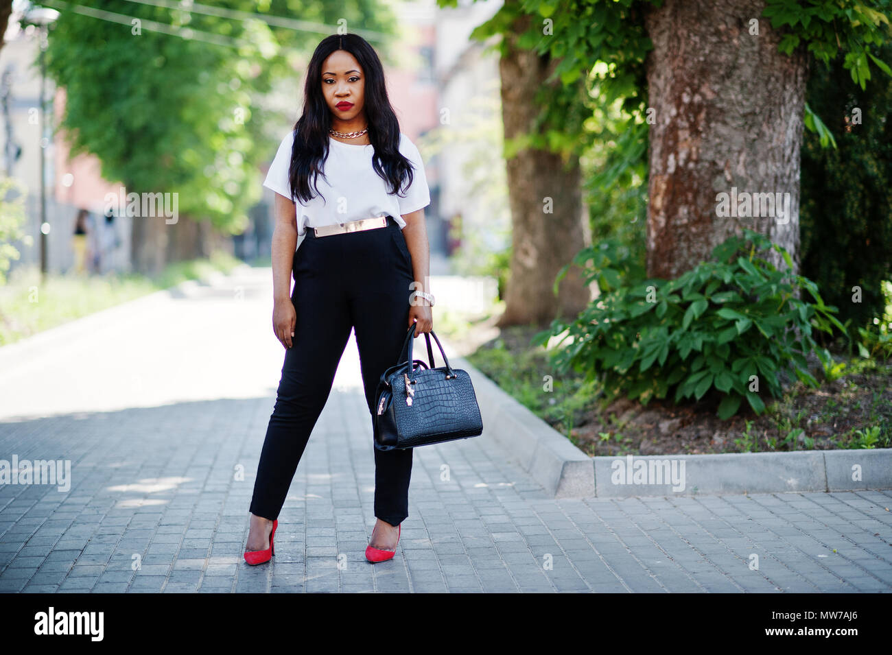 Stylish african american business woman on streets of city Stock Photo ...