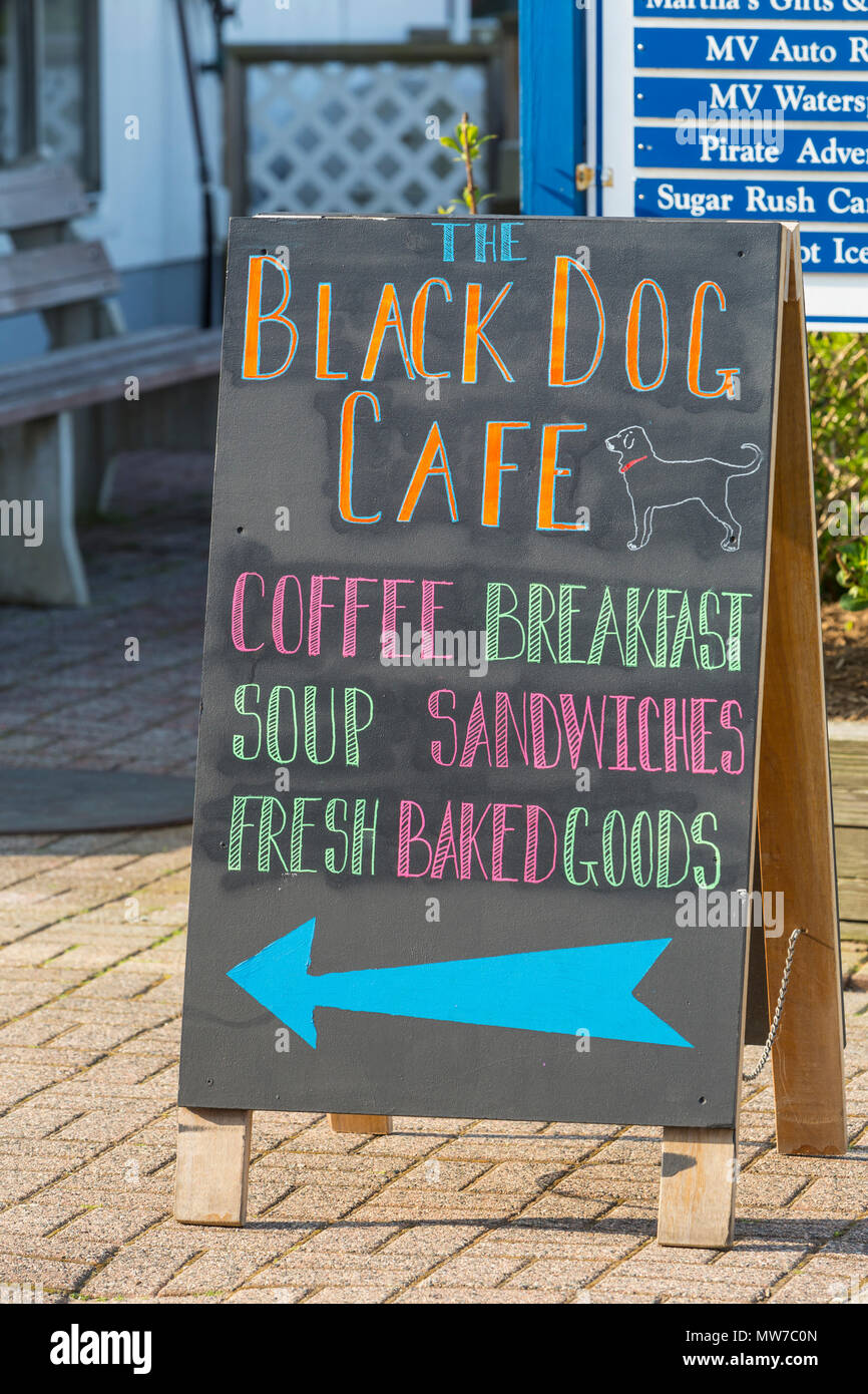 A sign points customers to the Black Dog Cafe in the Dockside Waterfront Marketplace on Oak Bluffs marina on Martha's Vineyard. Stock Photo