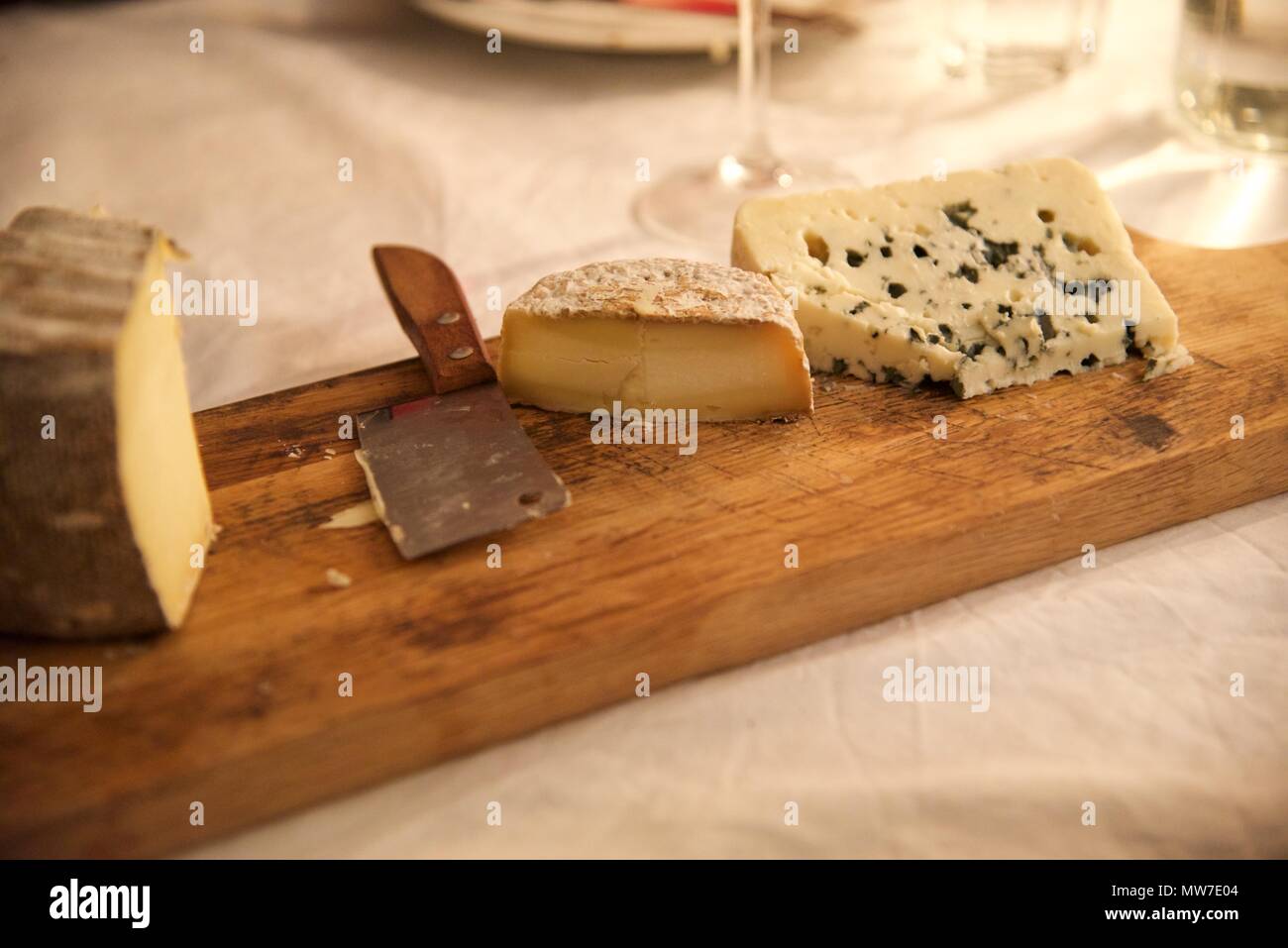 Cheese: real cheese on a real cheeseboard on a real French dinner table Stock Photo