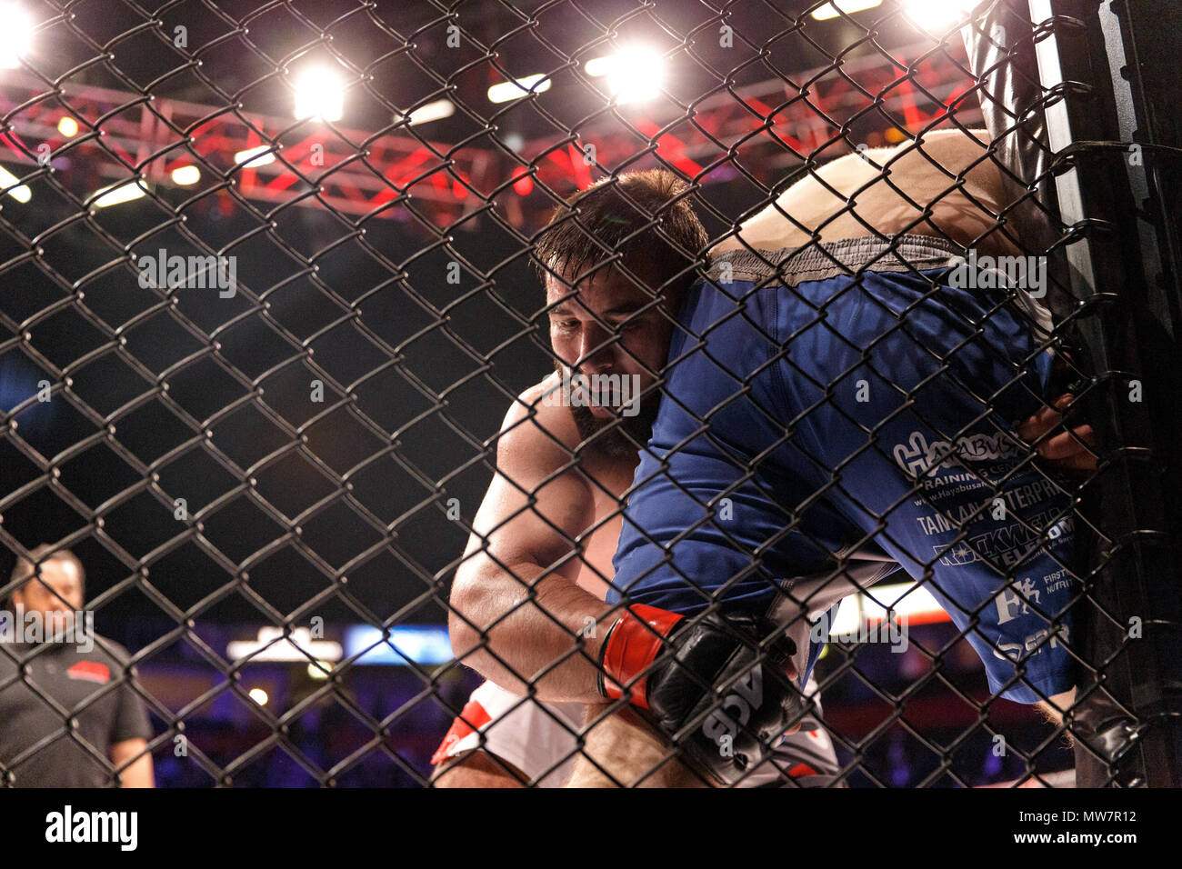 Mukhomad Vakhaev (close left, facing camera) holds Tanner Boser against the cage at ACB 54 in Manchester, UK. Absolute Championship Berkut, Mixed Martial Arts, MMA fight. Stock Photo