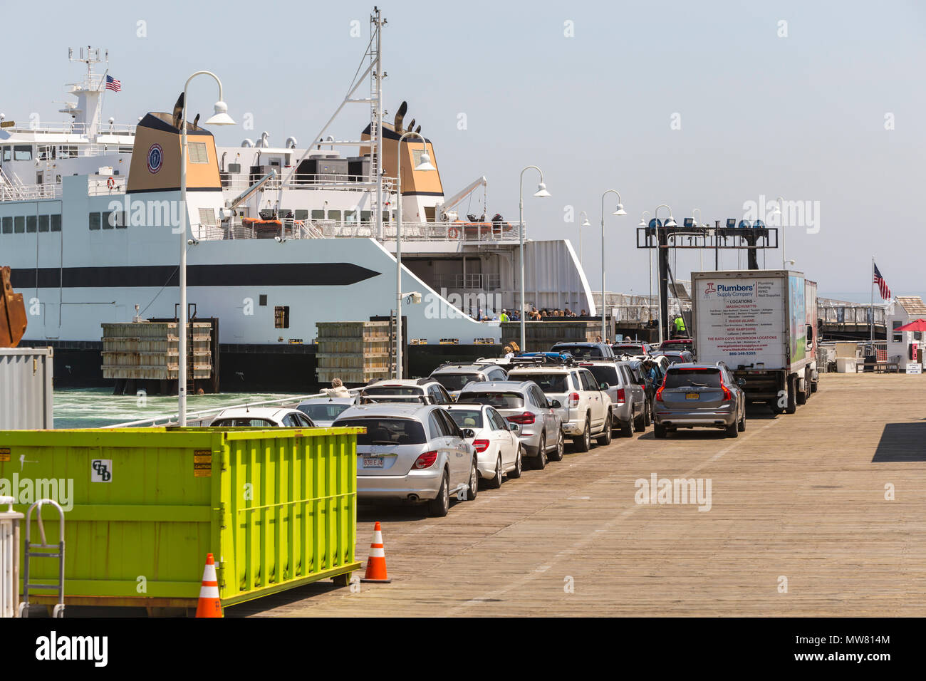 Vehicles wait in line to board a Steamship Authority ferry preparing to depart the ferry terminal in Oak Bluffs, Massachusetts on Martha's Vineyard. Stock Photo