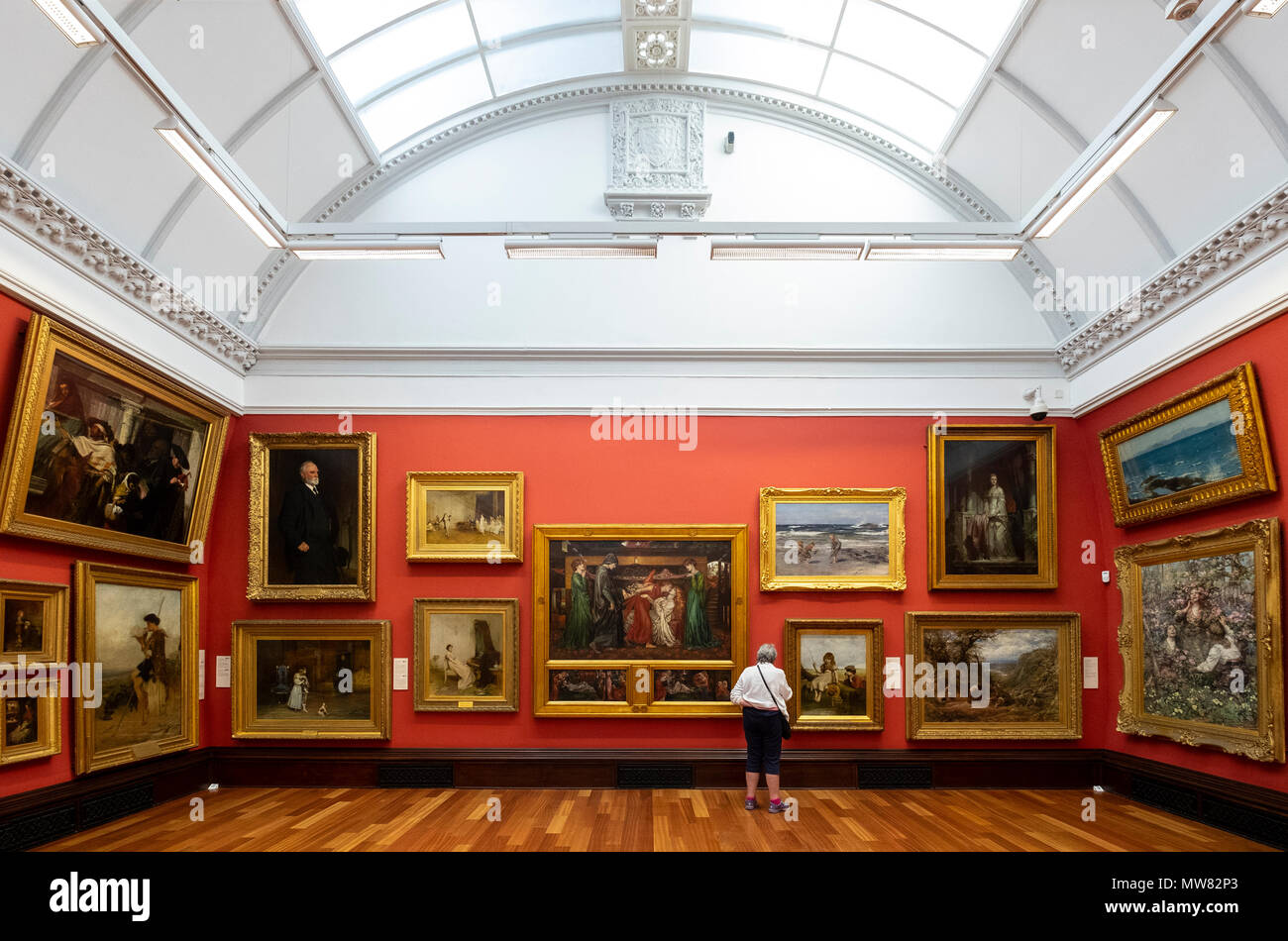 Woman looking at paintings in the Victoria Gallery  inside the McManus art gallery and museum in Dundee, Tayside, Scotland, UK Stock Photo