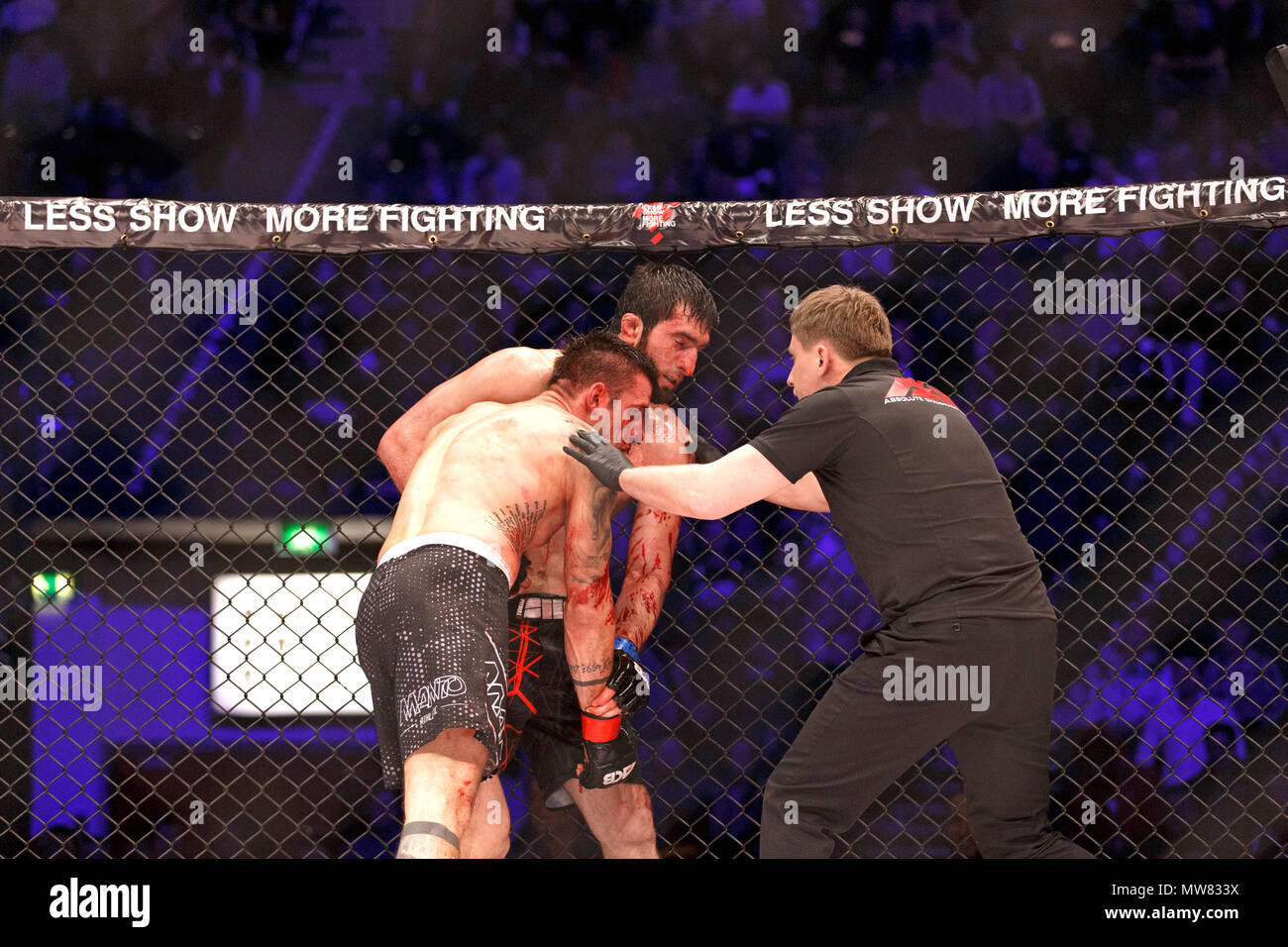 Abdul-Rakhman Dzhanaev versus Adam Zając at ACB 54 in Manchester, UK. Referee Viktor Korneev steps in to call for the doctor due to Zając's heavily blooded nose and lip. Dzhanaev was declared the winner due to a TKO by doctor's stoppage. Absolute Championship Berkut, Mixed Martial Arts, MMA fight. Stock Photo