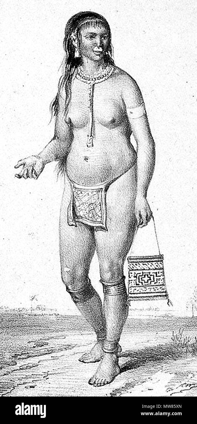 . An Arawak woman in traditional dress (1830): she wears an apron made of kweyou, adorned with beads, and adorning leg and ankle bands. A silver plate serves as a nose decoration. 1839. P.J. Benoît 57 Arowakse vrouw in klederdracht Stock Photo