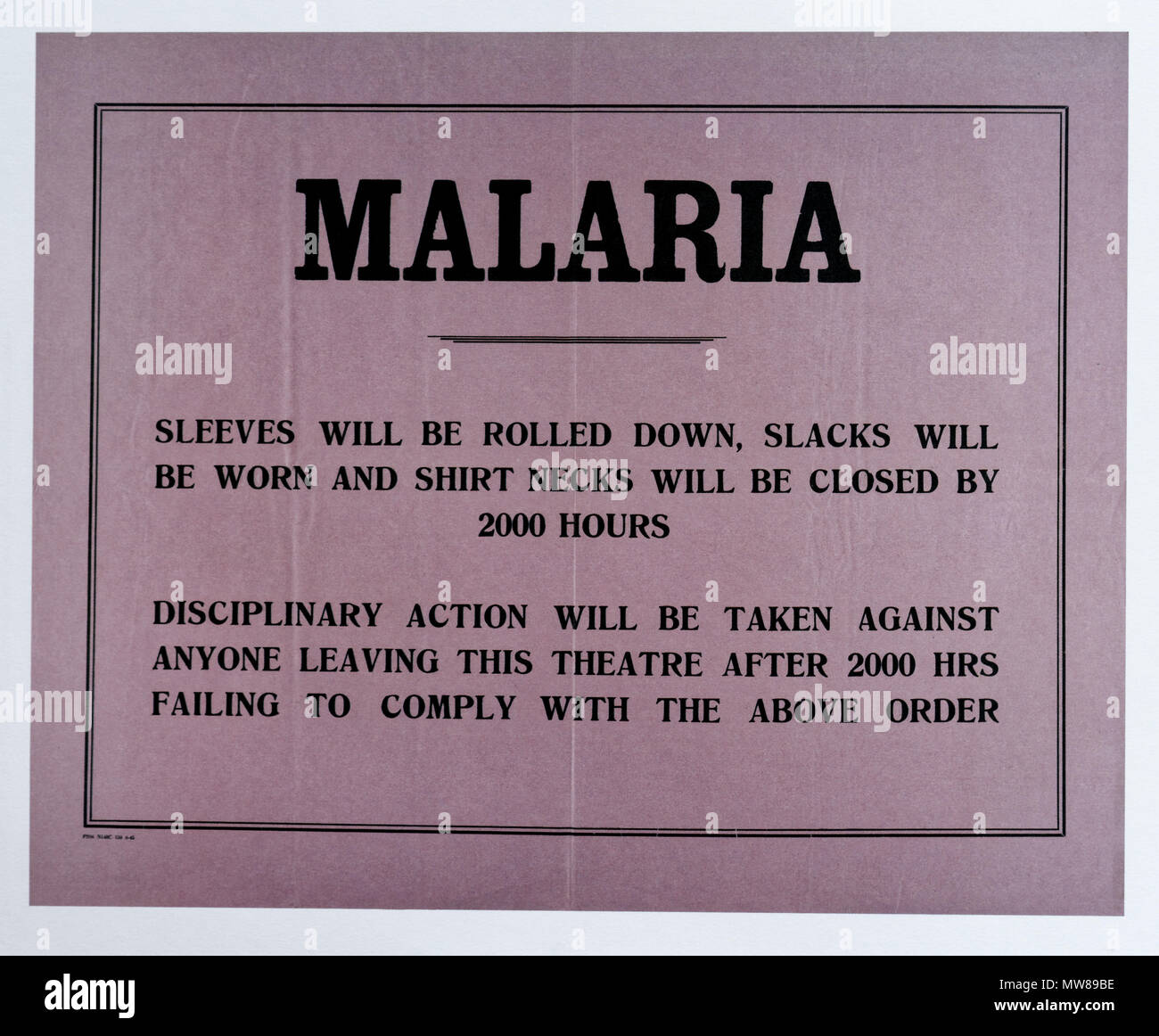 A Second World War poster containing advice on how to reduce the risk of malaria, and threatening discipline on those who don't follow the advice Stock Photo