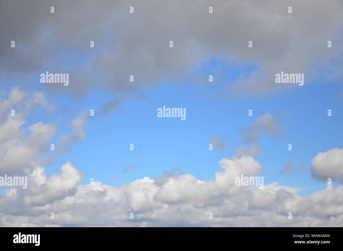 Heavenly space of blue color with a lot of thick white clouds ...