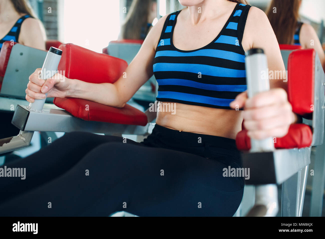 Young woman exercising abdominal muscles. Fitness in gym Stock Photo ...
