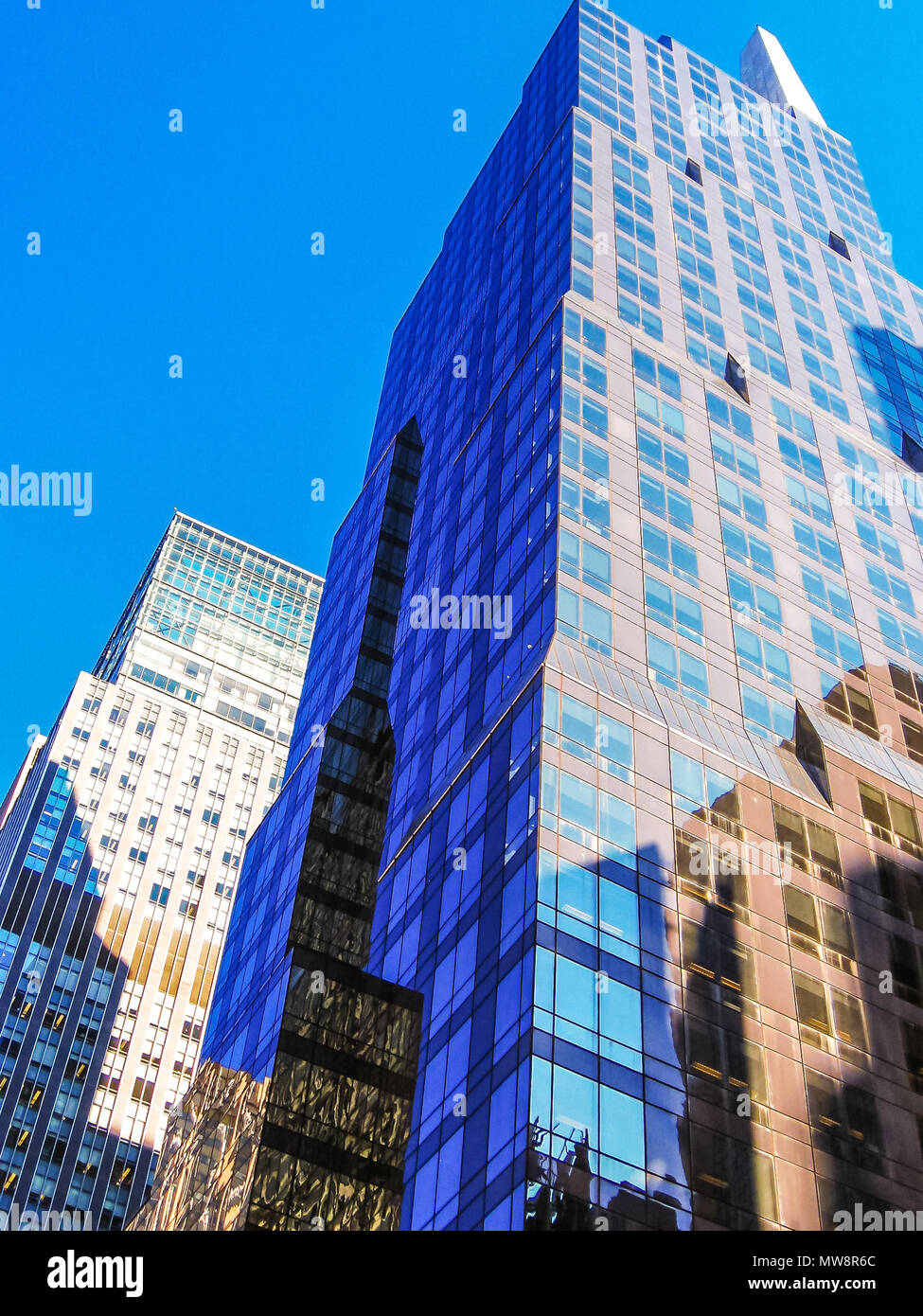 Vertical of modern shiny blue facade of high rise buildings in ...