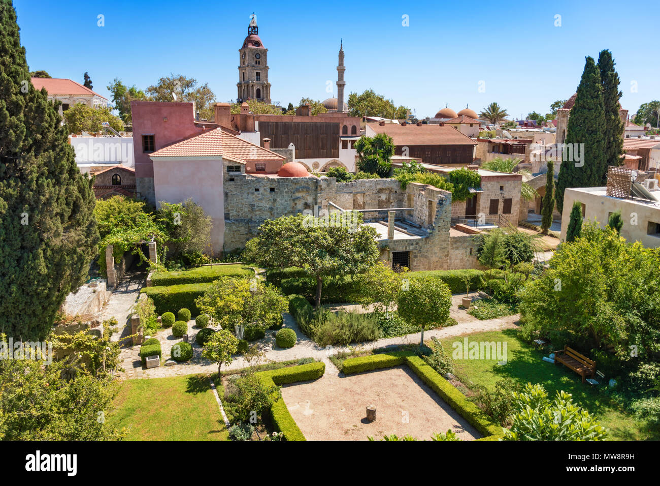 View from city walls into garden with historical buildings in City of ...