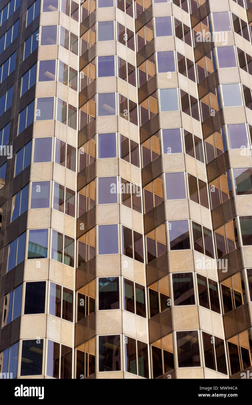 Rectangular windows of a high rise office building forming a repetitive pattern Stock Photo
