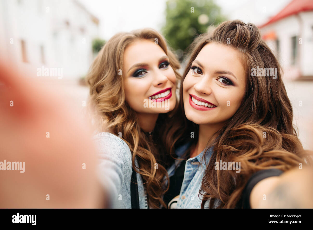 Pretty Teen Girls With Hairstyles And Red Lips Smiling At Camera