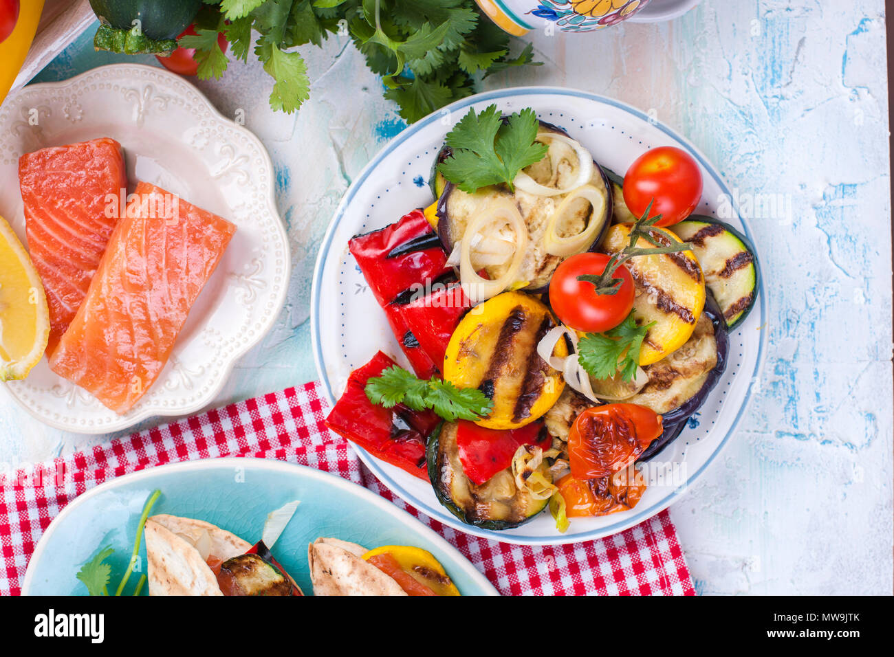 Grilled vegetables and salmon on a light background Stock Photo - Alamy