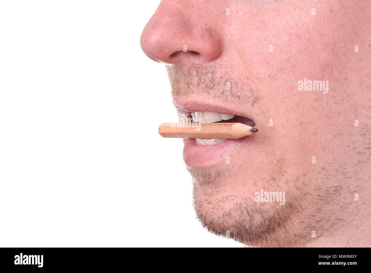 Close-up of man bitting pencil Stock Photo